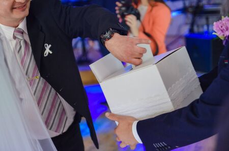 Bride and groom dancing the first dance at their wedding day. Guest on the dancefloorの写真素材