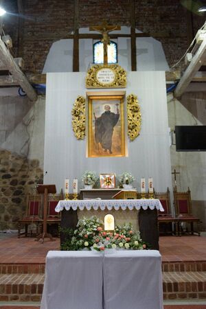 Church sanctuary before a wedding ceremony. Empty chairs for bride and groomの写真素材