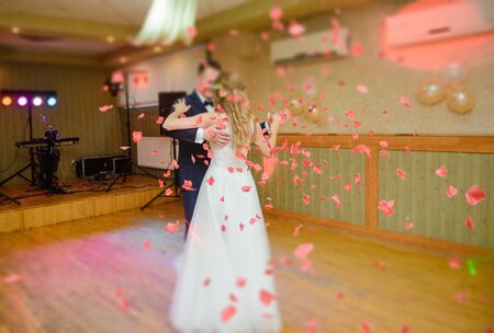 Bride and groom dancing the first dance at their wedding day. Guest on the dancefloor