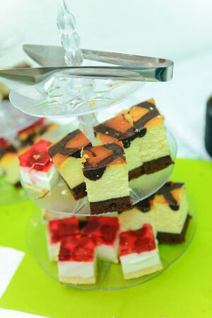 Delicious sweets on candy buffet. Wedding bakes on trays.の写真素材