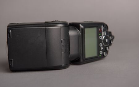 Camera off flash on the gray background. Photography equipmentの写真素材