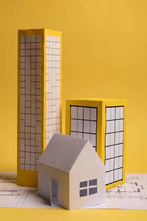 Yellow paper block of flats on yellow background paper. Minimalistic and simple concept, style. Copy space. Horizontal orientation.の写真素材