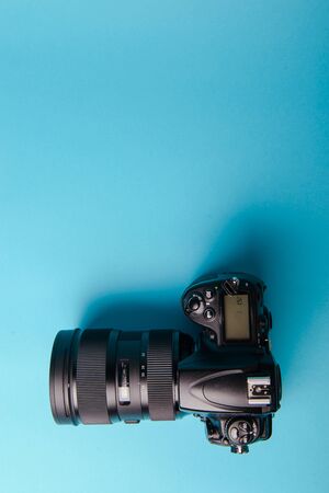 Professional modern DSLR camera against blue backgroundの写真素材