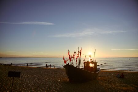 fisherman boats at sunrise time on the beach in summerの写真素材