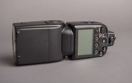 Camera off flash on the gray background. Photography equipmentの写真素材
