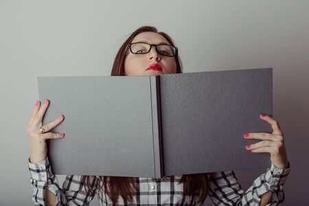 Business woman holding a wide open bookの写真素材