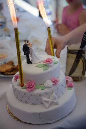 Delicious Wedding Cake at the party. Smoke and fire effectsの写真素材