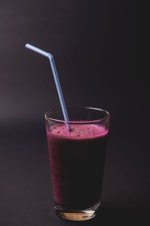 Blueberry smoothie with fresh berries, chia seeds and banana for breakfast on dark background, selective focusの写真素材