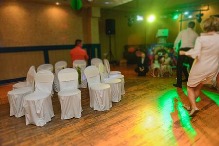 Bride and groom dancing the first dance at their wedding day. Guest on the dancefloorの写真素材