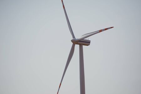wind trubine at sunny day with blue skyの写真素材