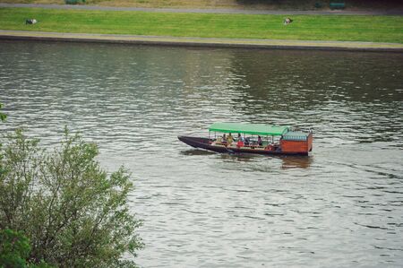 motor boat floats on the river in summer timeの写真素材