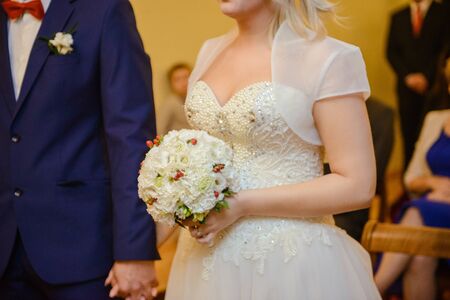 Bride and groom at church wedding during ceremony. Beautiful decorationの写真素材