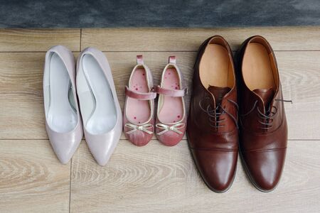 The bride shows white wedding shoes. Wedding detail. Close upの写真素材