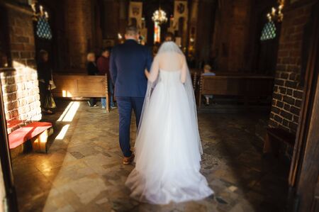 Bride and groom at church wedding during ceremony. Beautiful decorationの写真素材