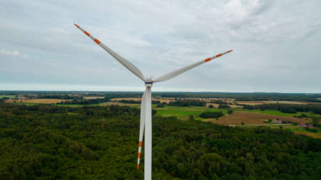 Aerial photo of windmills and blue sea at sunset.の写真素材