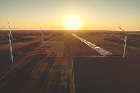 Aerial photo of windmills and blue sea at sunset.の写真素材