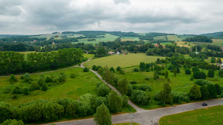 drone flying over mountains. white drone hovering in a bright blue sky. New technology in the aero photo shootingの写真素材