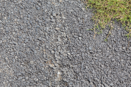 Texture on cement ground view stone with grass in top right background.の写真素材