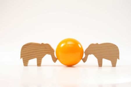 wooden elephants pushing the ballの写真素材