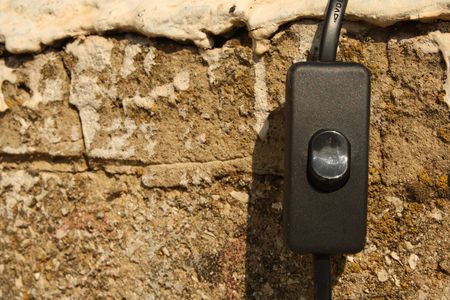 power switch is hanging on the old wallの写真素材