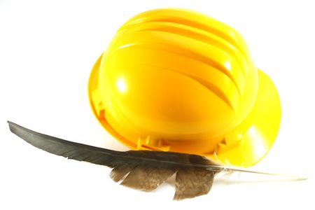 yellow helmet and Eagle feathers on a white backgroundの写真素材