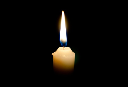 Burning candle on a black backgroundの写真素材