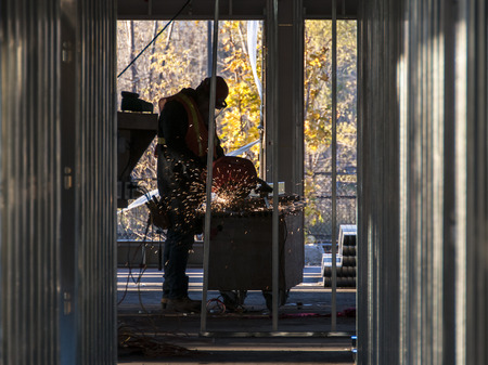 Worker sawing metalの写真素材