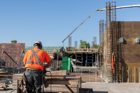Construction worker using a saw and concreteの写真素材