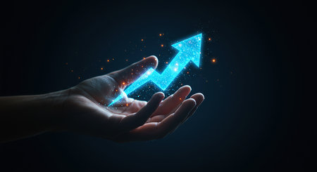A close-up shot of a hand holding a vibrant glowing blue arrow pointing upwards signifying progress achievement and forward momentum in business or personal development.の素材