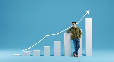 A man stands confidently beside a rising bar chart, symbolizing financial growth and business success. The upward arrow indicates positive progress and future potential.の素材