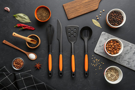 Flat lay composition with kitchen utensils and spices on black backgroundの素材