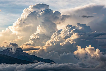 Dramatic cloudscape over the mountain peaks at sunset, Alps, Switzerlandの素材