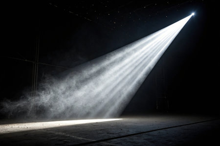 Spotlight in a dark room with smoke and rays of light.の素材
