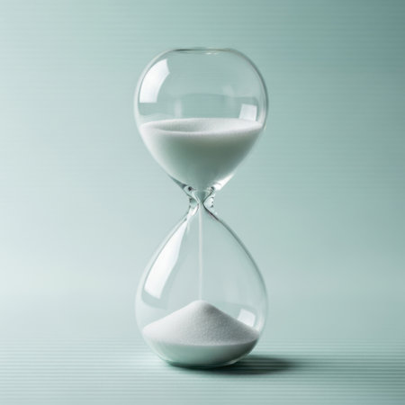 Hourglass on blue background. Concept of time management and deadline.の素材