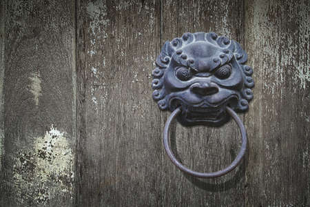 Chinese Style Lion Head Door Handle on Wood Backgroundの写真素材