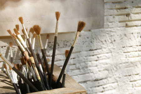 Artist Paint Brushes with White Brick Wall Backgroundの写真素材