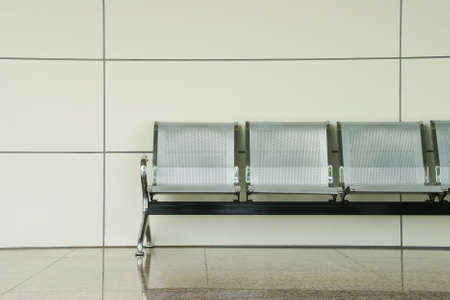 Modern Metal Chairs Against White Wall in Waiting Area
