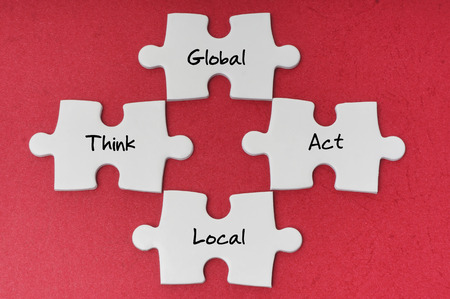 Think Global, Act Local word on white puzzleの写真素材