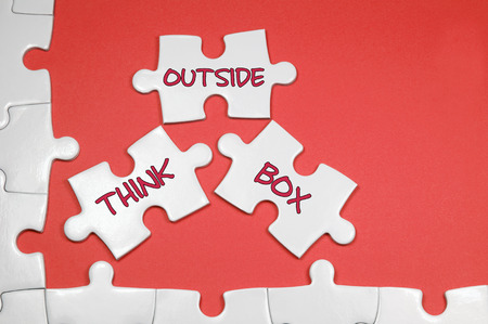 Think Outside Box word on white puzzle - Business Conceptの写真素材