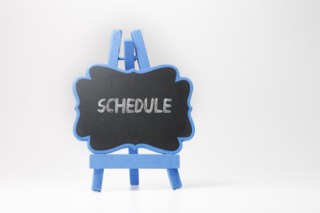 Schedule  text on blackboard isolated on white backgroundの写真素材