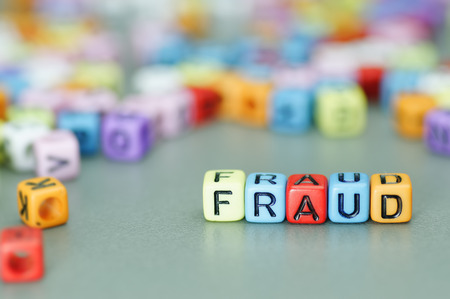 Fraud word on colorful dicesの写真素材
