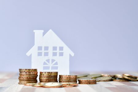 Close up of Wooden home and stack money coins of property investment conceptの写真素材