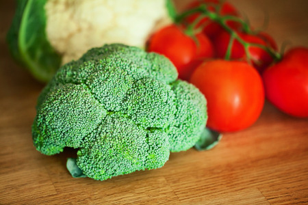 Broccoli, Cauliflower, tomato on the wooden boardの写真素材