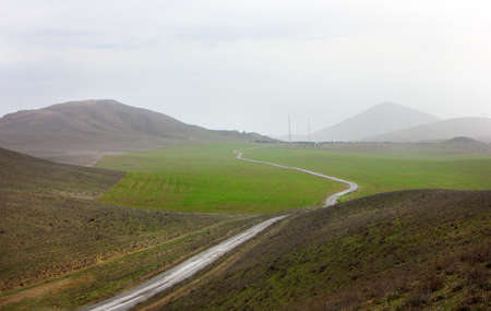 The road leading to the beautiful mountains. Gobustan region. Azerbaijan.