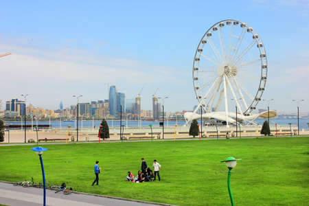Baku. Azerbaijan. 04.15.2017 Cyclists rest on the green grass on the boulevard.のeditorial素材