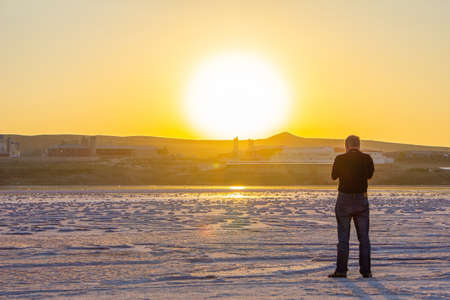 The photographer takes pictures of the salt on the lake. Baku. Azerbaijan.の写真素材