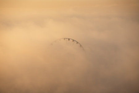 baku city. Azerbaijan. May 16, 2021. Ferris wheel on the boulevard with fog.のeditorial素材