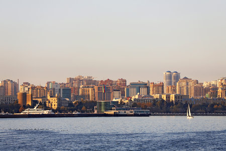 baku city. Azerbaijan. 09.11.2020 year. Beautiful sailing boat on the background of the city.のeditorial素材