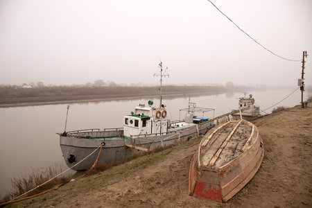 The city of Neftekala, Azerbaijan. 01.28.2021. Ships docked on the bank of the Kura River.のeditorial素材