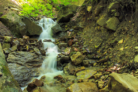 A small beautiful waterfall in the mountains. Shabran region. Azerbaijan.の写真素材